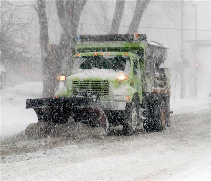 Plow truck In New England during winter storm